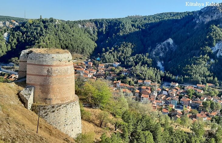 kütahya kalesi yuvarlak burç, savunma duvarlari, geniş ormanlık vadi ve kütahya şehir manzarası, yüksekten bakış
