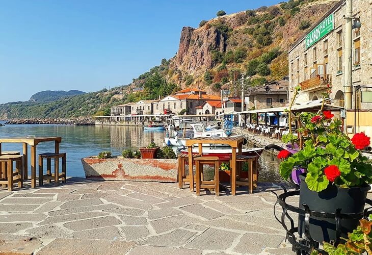 Assos liman sahilinde denize sıfır kafe ve restoranlar, taş binalar